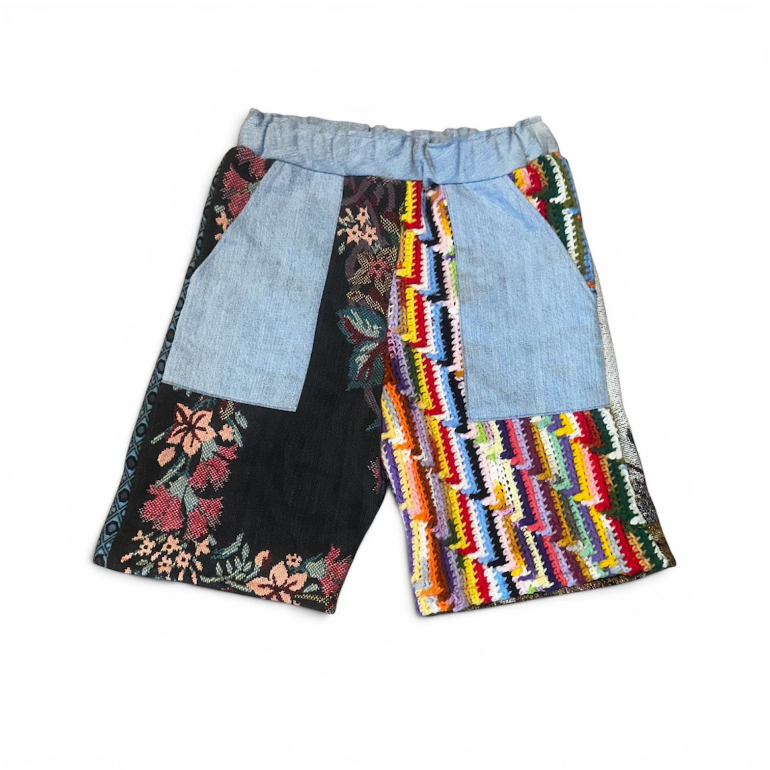 Colorful patchwork shorts with floral, geometric, and striped patterns on a white background