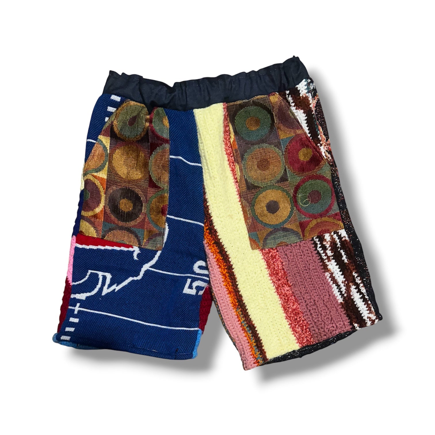 Colorful patchwork shorts with geometric patterns on a white background